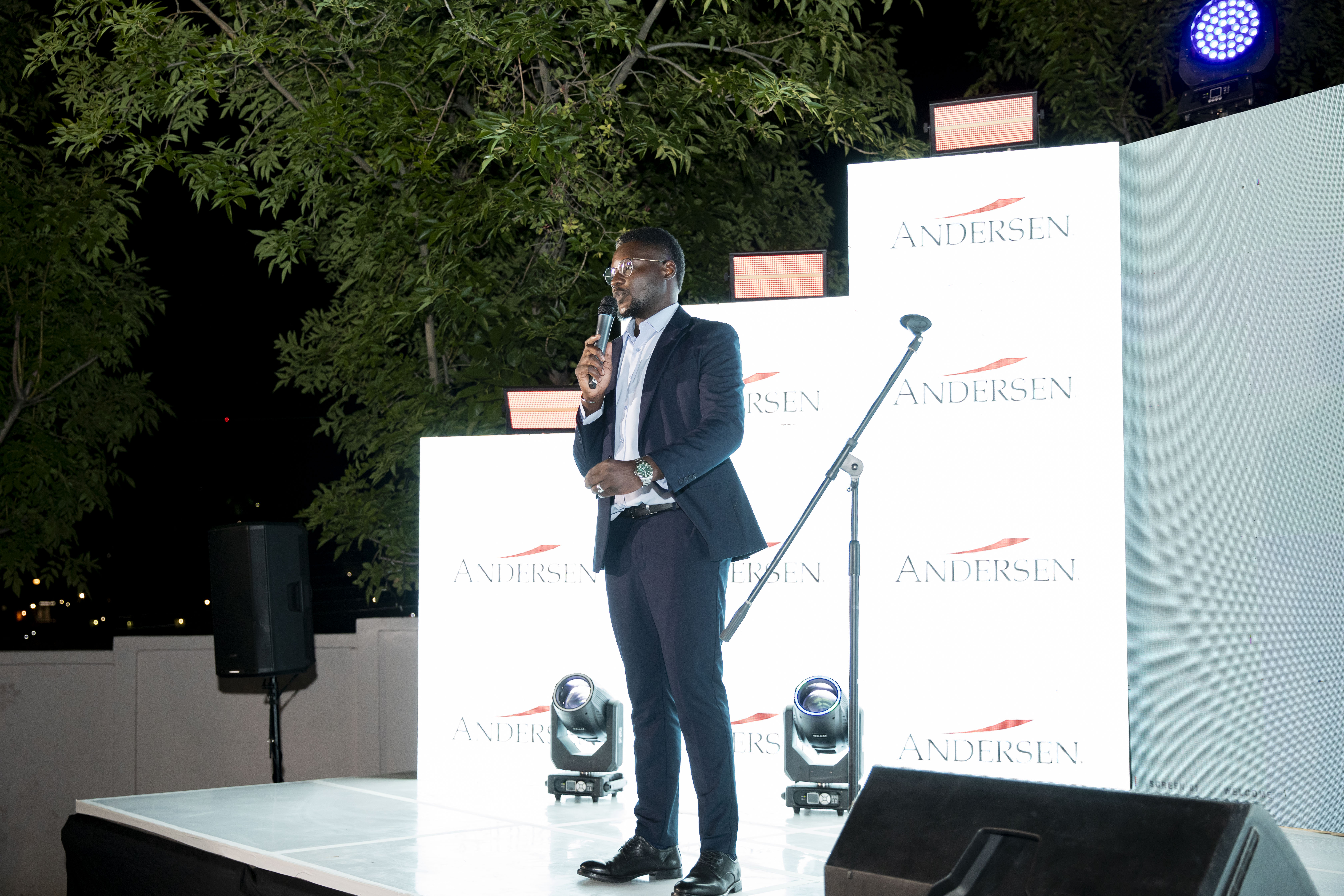 Andersen in Namibia leader speaking in front of the Andersen brand wall