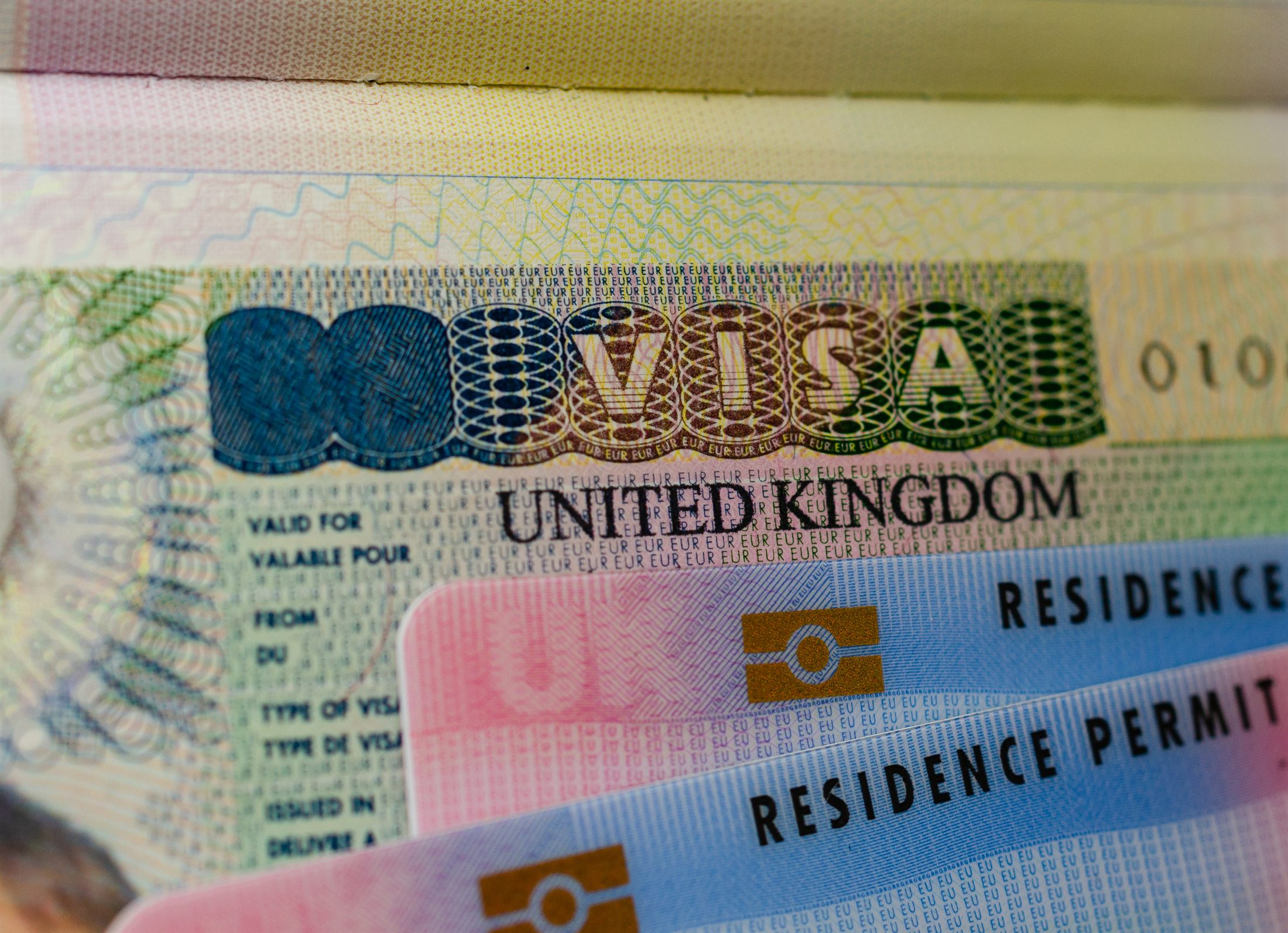 UK biometric residence permit cards on a passport