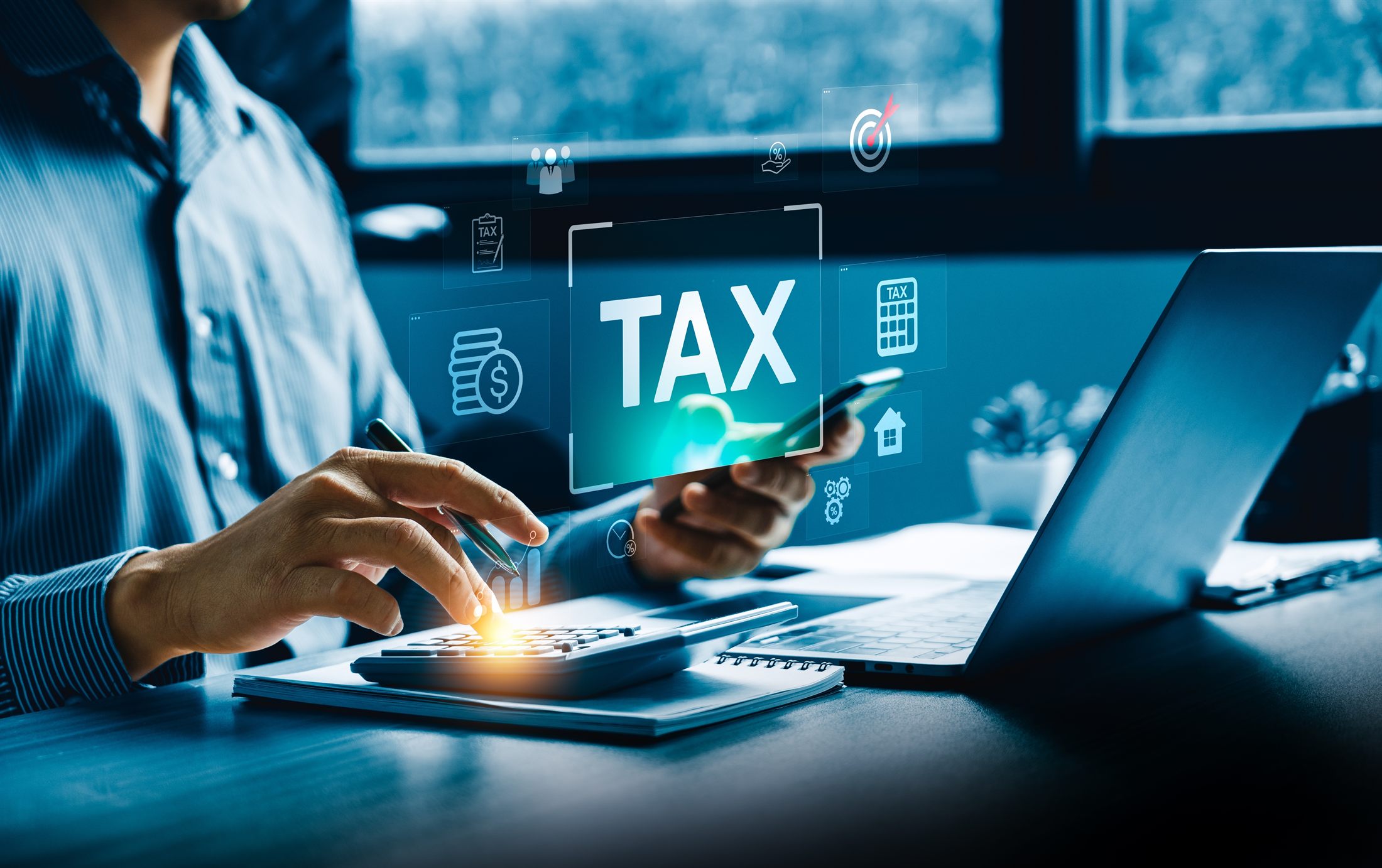 Professional calculating taxes using digital tools